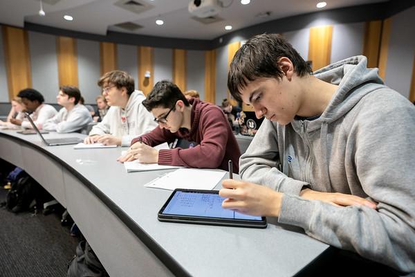 Students at long desk in classroom